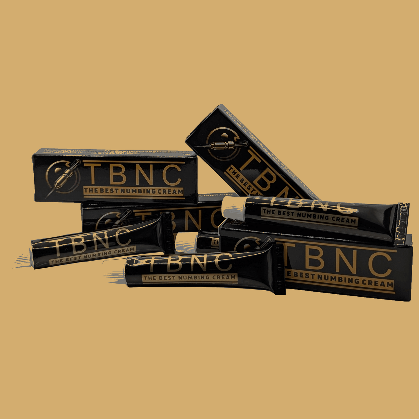 Tubes and boxes of TBNC - The Best Numbing Cream - 4 Pack feature sleek black packaging with gold text, stating "The Best Numbing Cream for a Tattoo Painless Experience," casually arranged against a plain brown background.