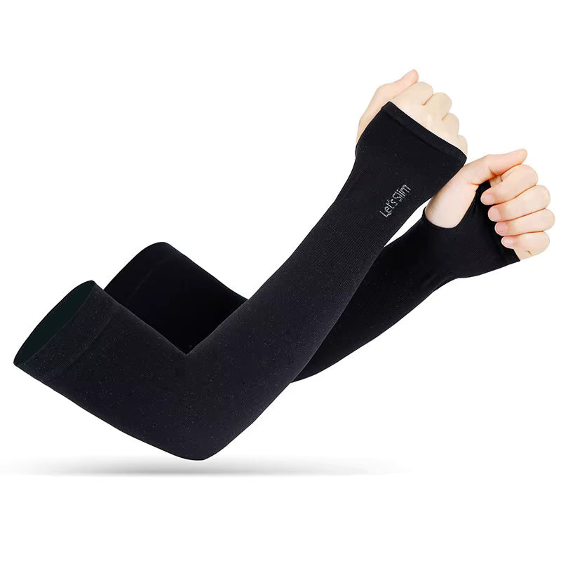 A pair of crossed arms wear TBNC - The Best Numbing Cream TattooGuard SPF Sun Protection Sleeves, long and black with thumb holes. These sleeves offer UV protection from hands to upper arms—perfect for tattoo care against the sun. White background.