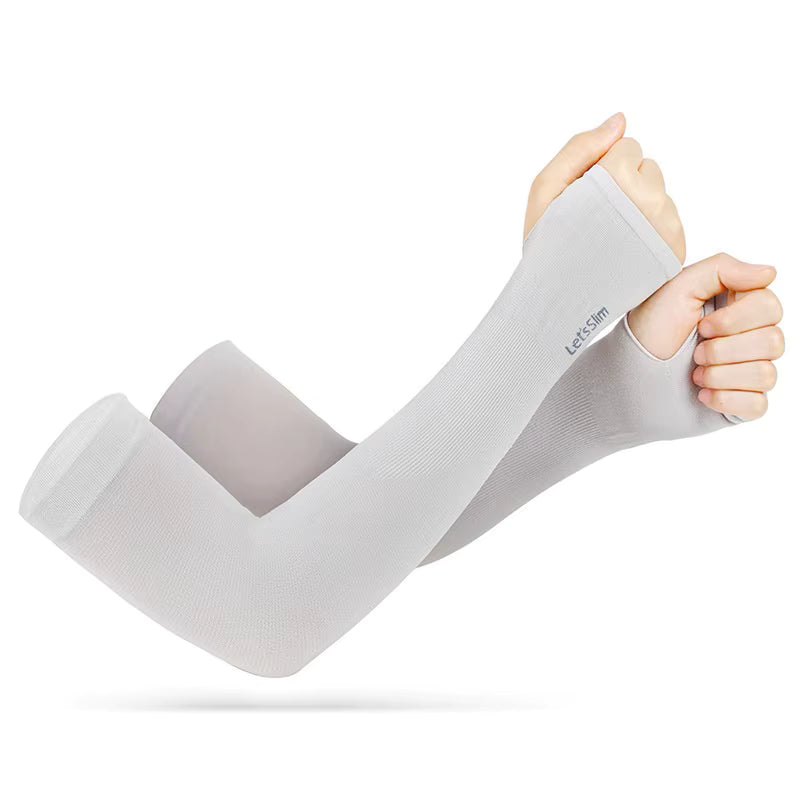 Two hands wear light gray TattooGuard SPF Sun Protection Sleeves with thumb holes by TBNC - The Best Numbing Cream, covering from wrist to upper arm for UV protection and comfort during everyday activities.