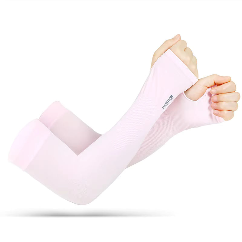 Two hands wear light pink TattooGuard SPF Sun Protection Sleeves by TBNC. The fitted sleeves with thumb holes extend from wrist to above elbow, offer UV protection, and have "FASHION" printed near the wrist area.