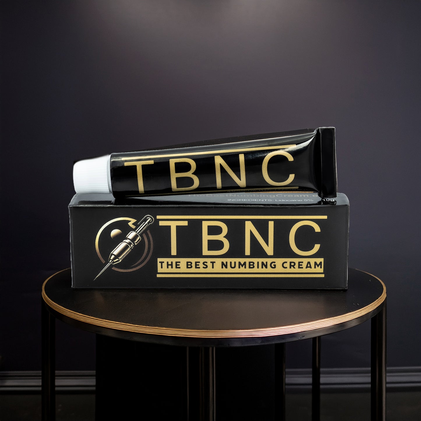 A 10-pack of TBNC - The Best Numbing Cream is displayed in sleek black and gold packaging with a needle illustration, highlighting its effectiveness as a tattoo numbing cream from the TBNC brand.
