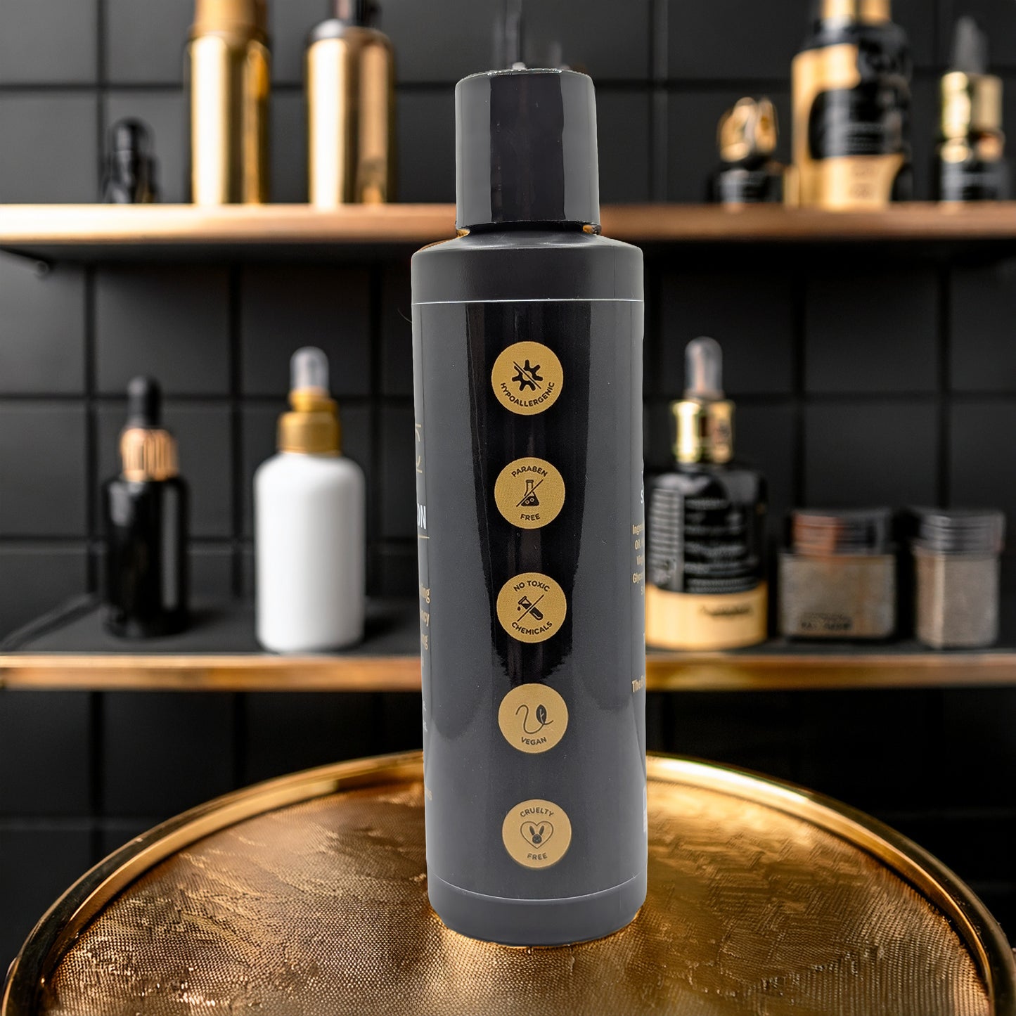 A sleek black TBNC - The Best Numbing Cream Tattoo Aftercare Lotion - Unscented sits on a gold surface, adorned with gold icons—sun, scissors, tool, snake, and heart—amidst matching black and gold skincare products. Perfect for tattoo aftercare.
