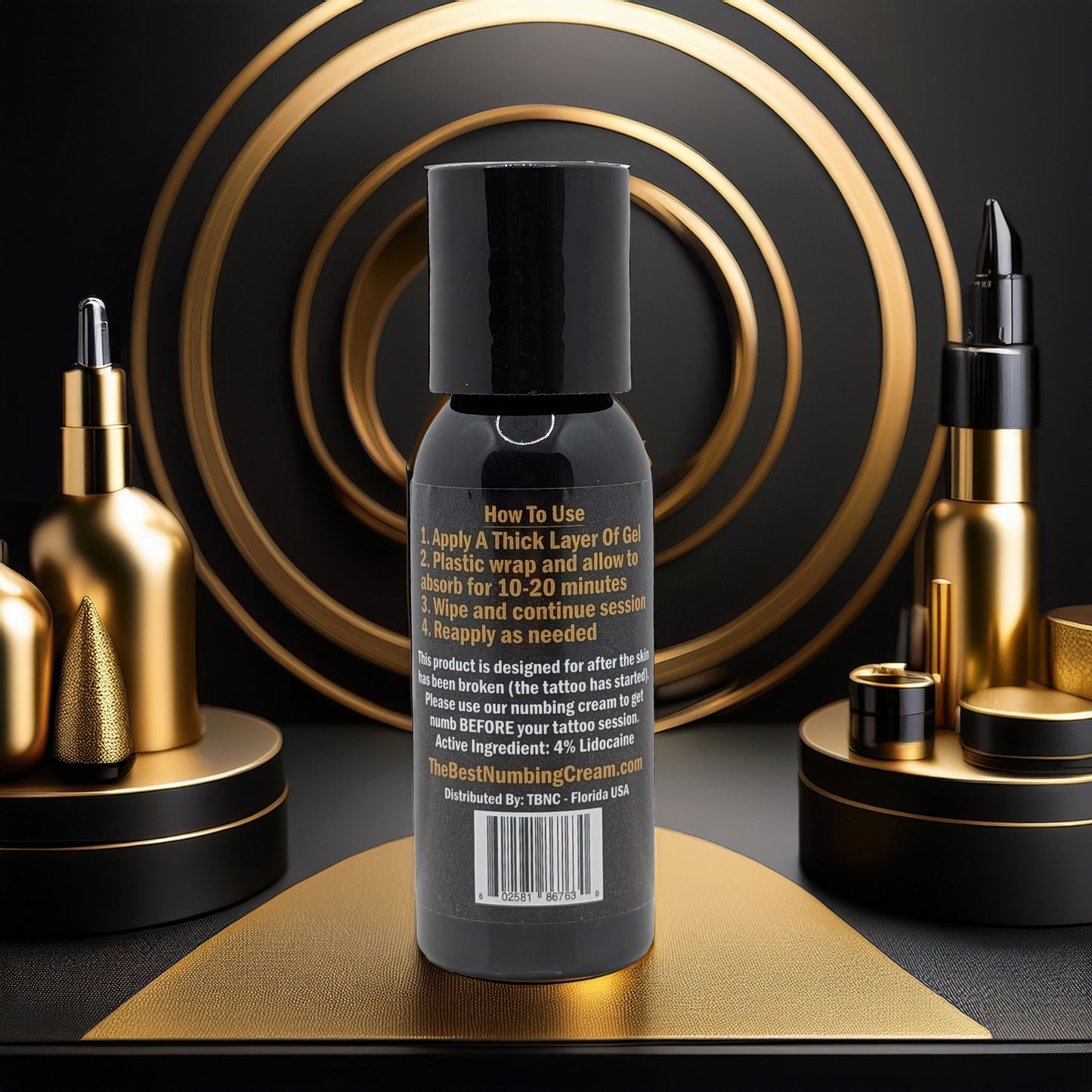 A black bottle with gold accents features Tattoo Numbing Gel - Mid Session by TBNC - The Best Numbing Cream. Surrounded by luxury cosmetics and geometric designs, it highlights fast pain relief in an elegant, modern setting.