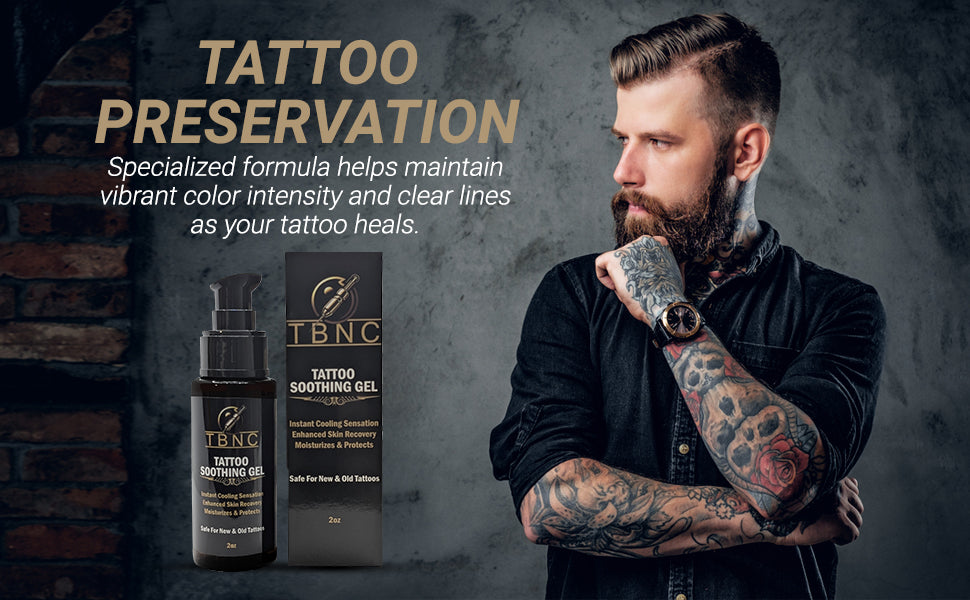 A tattooed, bearded man stands thoughtfully beside a TBNC - The Best Numbing Cream Tattoo Soothing Gel bottle and box. The gel boosts tattoo vibrancy and helps preserve color for long-lasting clarity.