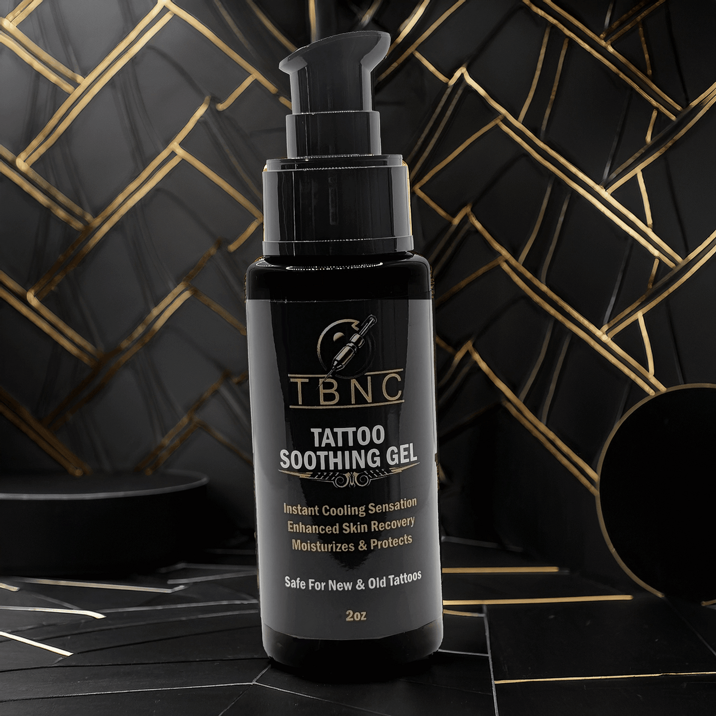 This 2 oz TBNC Tattoo Soothing Gel, with a pump, showcases tattoo vibrancy on a black and gold geometric label. It highlights cooling sensations, skin recovery, and moisturizing benefits for both new and old tattoos.
