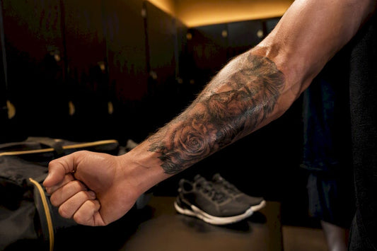 Close-up of tattooed arm stretching post-gym