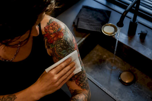 Fresh color tattoo being gently patted dry