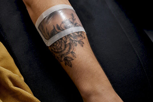 Fresh tattoo beneath a breathable dressing