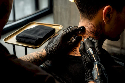 Artist tattooing detailed neck line work