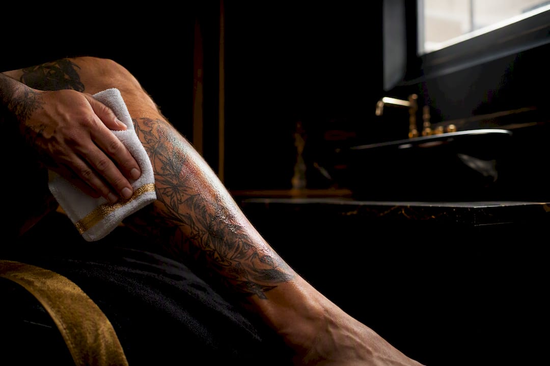 Healing tattoo being gently patted dry