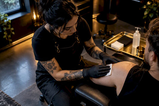 Artist examining clean skin before tattooing