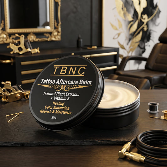 TBNC—The Best Numbing Cream Tattoo Aftercare Balm—open on a pro studio table, creamy formula shining beside inks and gear.