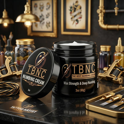 TBNC - The Best Numbing Cream MAX, trusted by top artists, stands open among tools in a pro studio; "Max Strength & Deep Numbing.