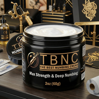 A 2 oz (60g) jar of TBNC Tattoo Numbing Cream MAX sits on a studio table, boasting max strength for ultimate tattoo comfort.