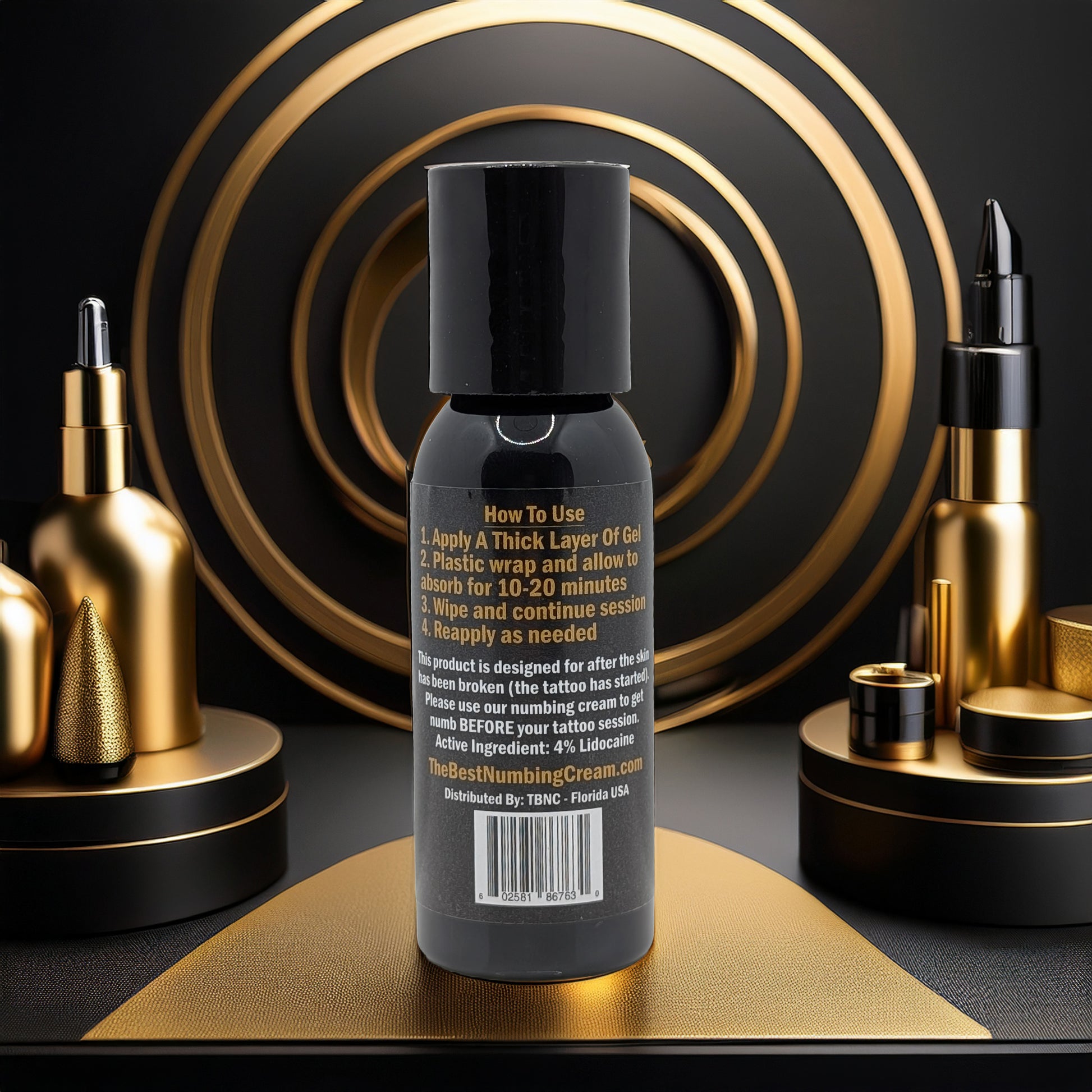 A black bottle with gold accents features Tattoo Numbing Gel - Mid Session by TBNC - The Best Numbing Cream. Surrounded by luxury cosmetics and geometric designs, it highlights fast pain relief in an elegant, modern setting.