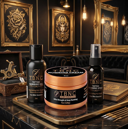 Ultra Tattoo Numbing Bundle—gel, cream, spray—displayed with elegant decor and tattoo tools for top-tier pain-free care.