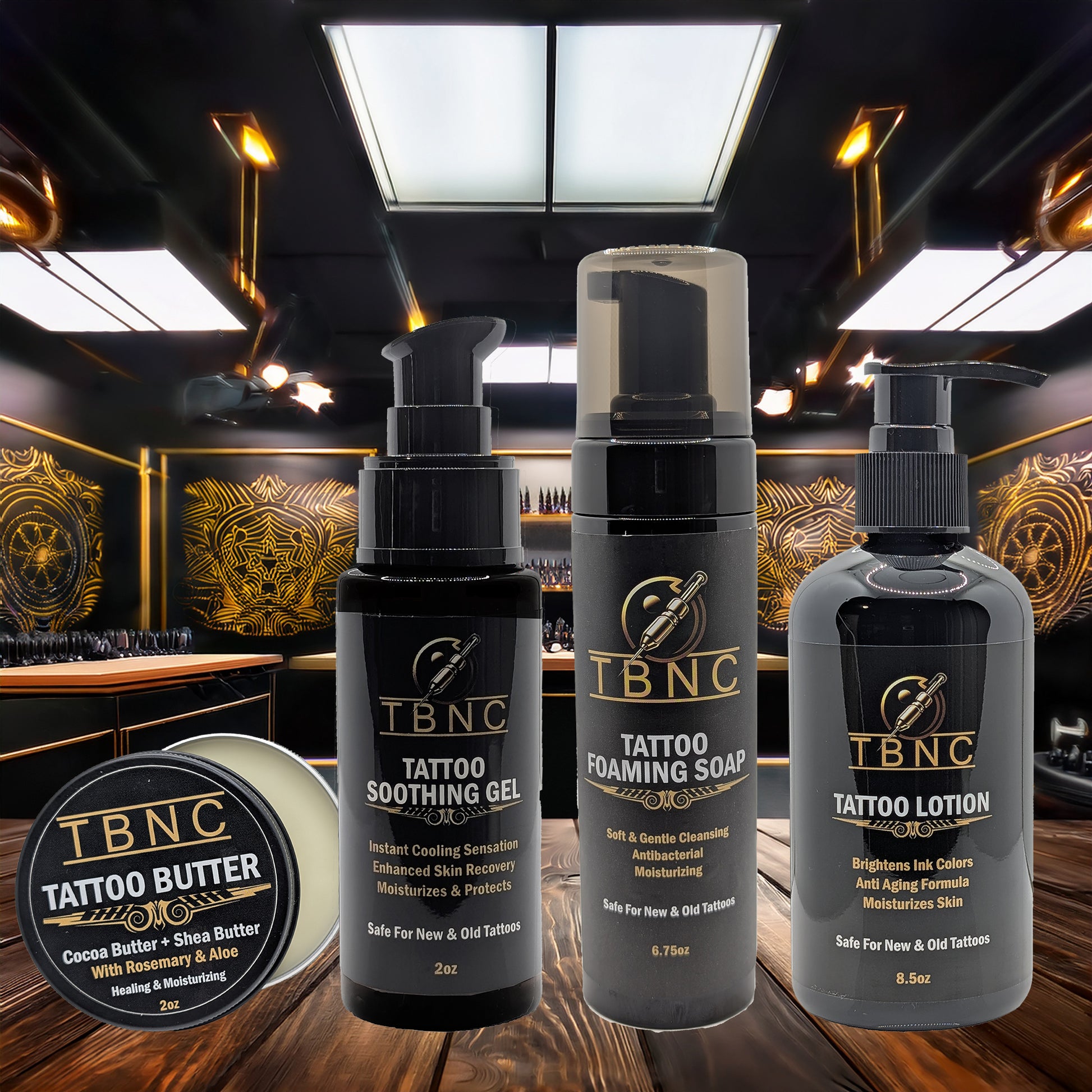 The TBNC – The Best Numbing Cream Tattoo Aftercare Bundle is displayed on a wooden surface in a tattoo studio, offering a complete aftercare solution with products all labeled under the TBNC brand.