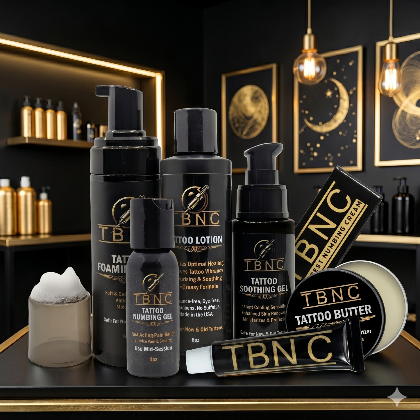 Top-selling TBNC Tattoo Numbing & Aftercare Bundle showcased on a table in a sleek black-and-gold room with art and shelving.