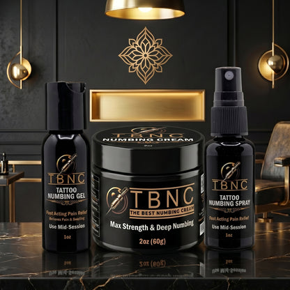 Top-selling TBNC Max Tattoo Numbing Bundle on a sleek counter in an upscale black-and-gold studio, beautifully illuminated.