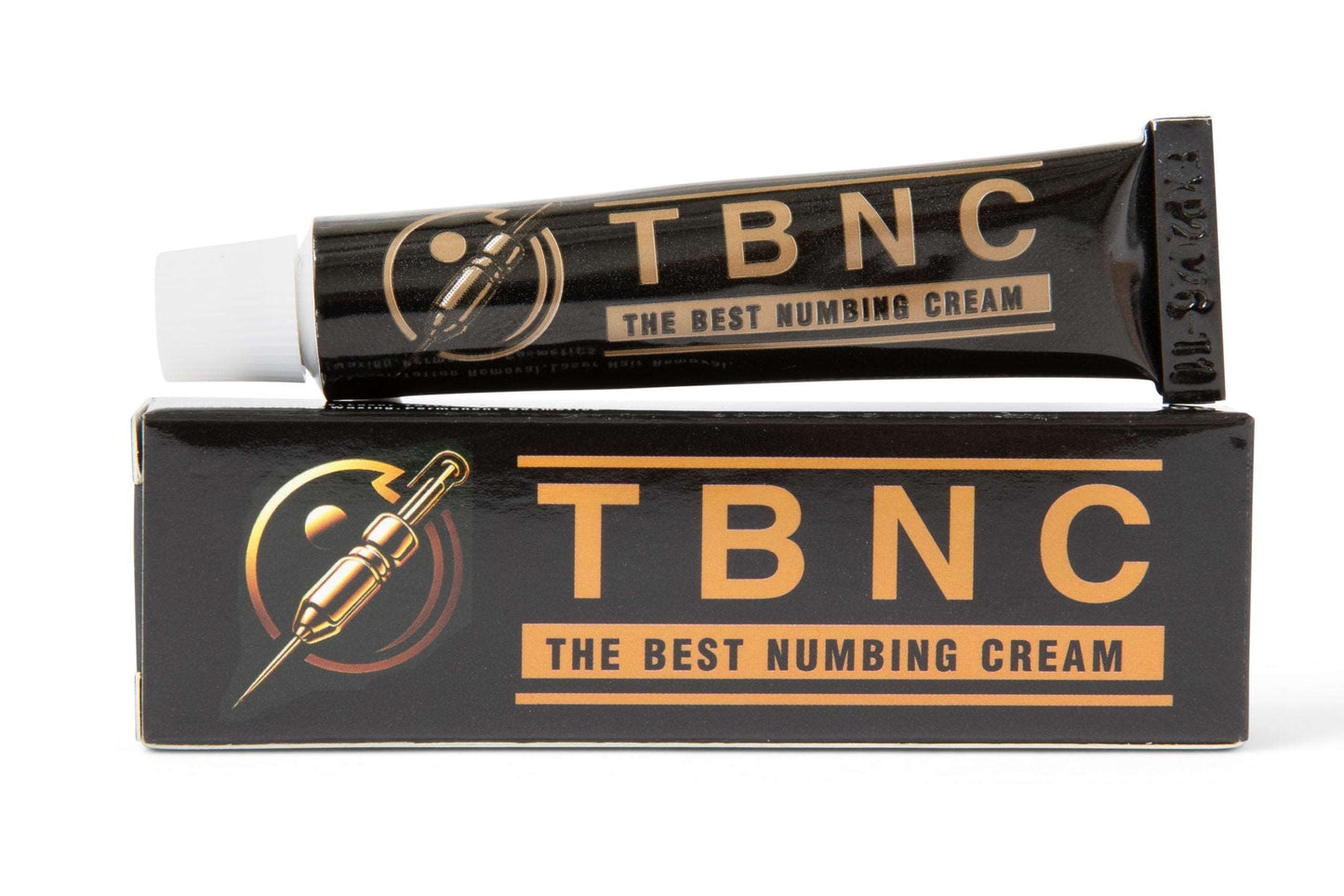 A black tube of TBNC - The Best Numbing Cream from a 6-pack rests on top of its matching black box, which features the same logo with an image of a needle and the text "The Best Numbing Cream" in orange letters. This product promises painless tattoos with its advanced numbing properties.