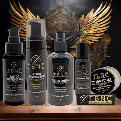 The TBNC - The Best Numbing Cream Tattoo Numbing & Aftercare Bundle is displayed before a gold winged emblem on a dark background, emphasizing its premium brand image.