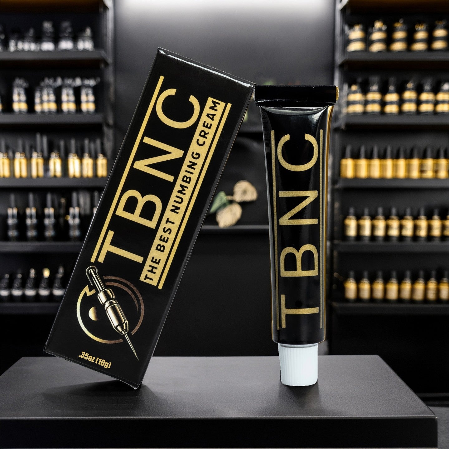 Top-selling TBNC numbing cream box and tube on a black table, shelves visible in the background.